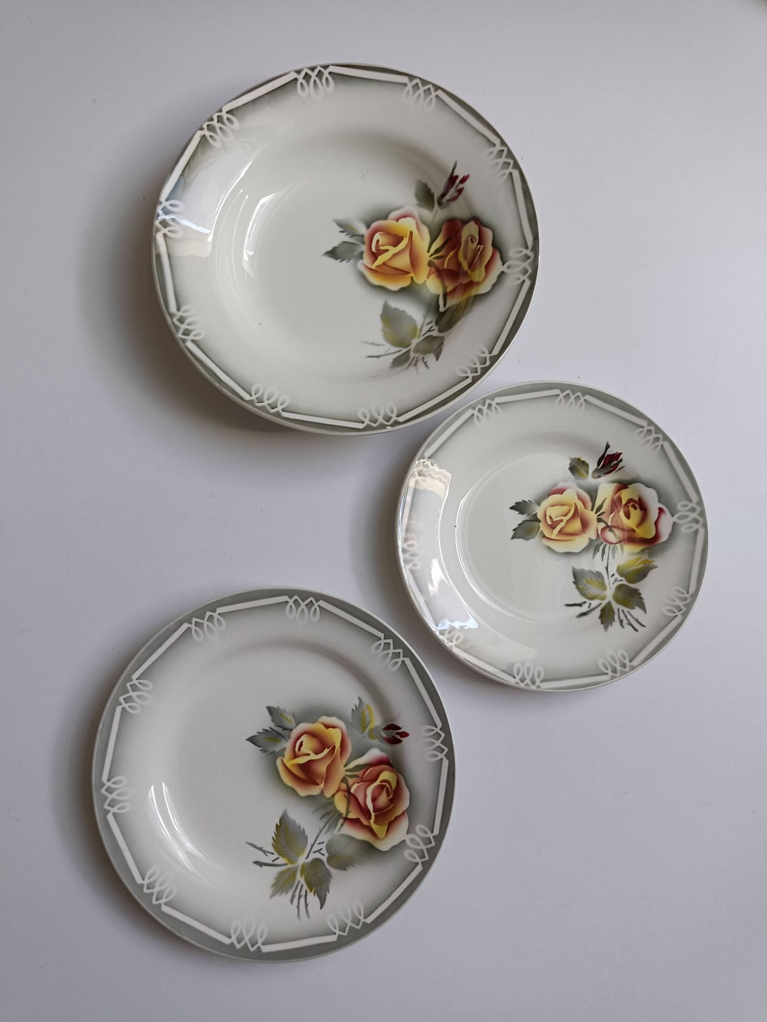 3 Digoin Sarreguemines Adèle plates in grey, yellow, and burgundy.