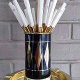 Vintage floor ashtray with a gold and black metal cigarette dispenser.
