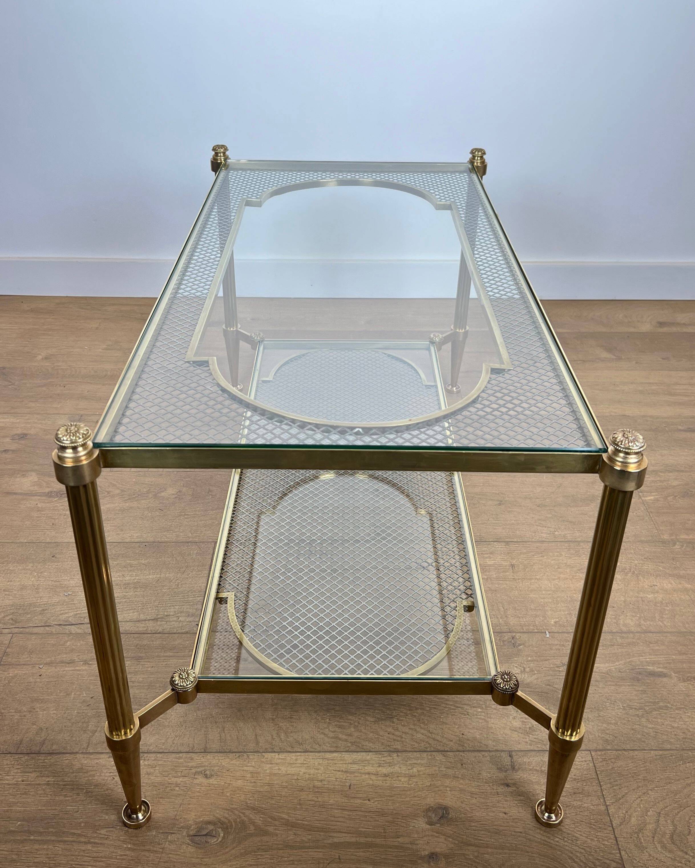 Rare bronze, brass, and steel mesh coffee table with a double glass top resting on a brass mesh. French work by Jansen