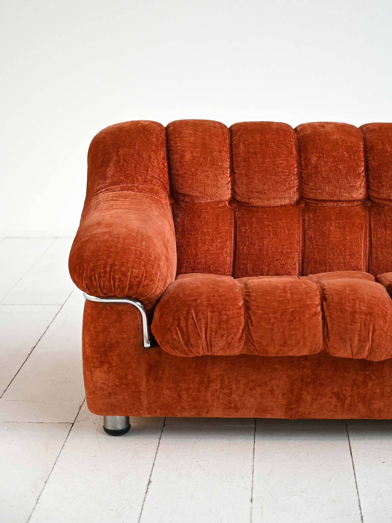 Vintage rust velvet sofa from the 1970s with metal details.