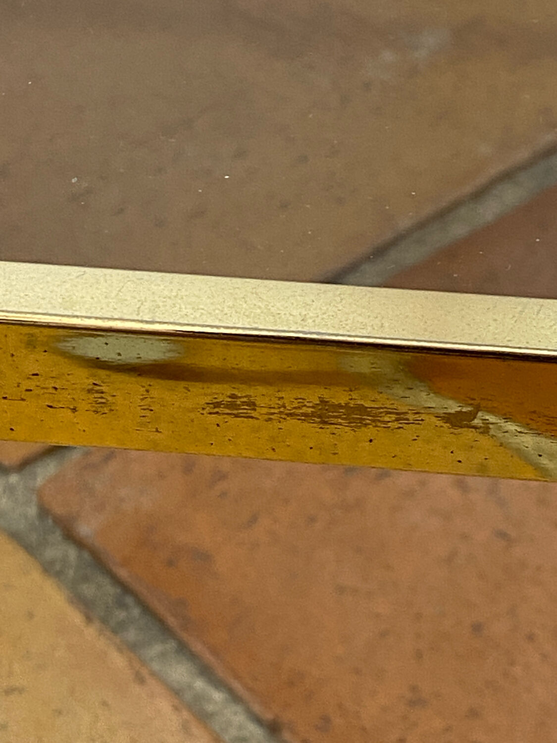 Gold metal and smoked glass console table.