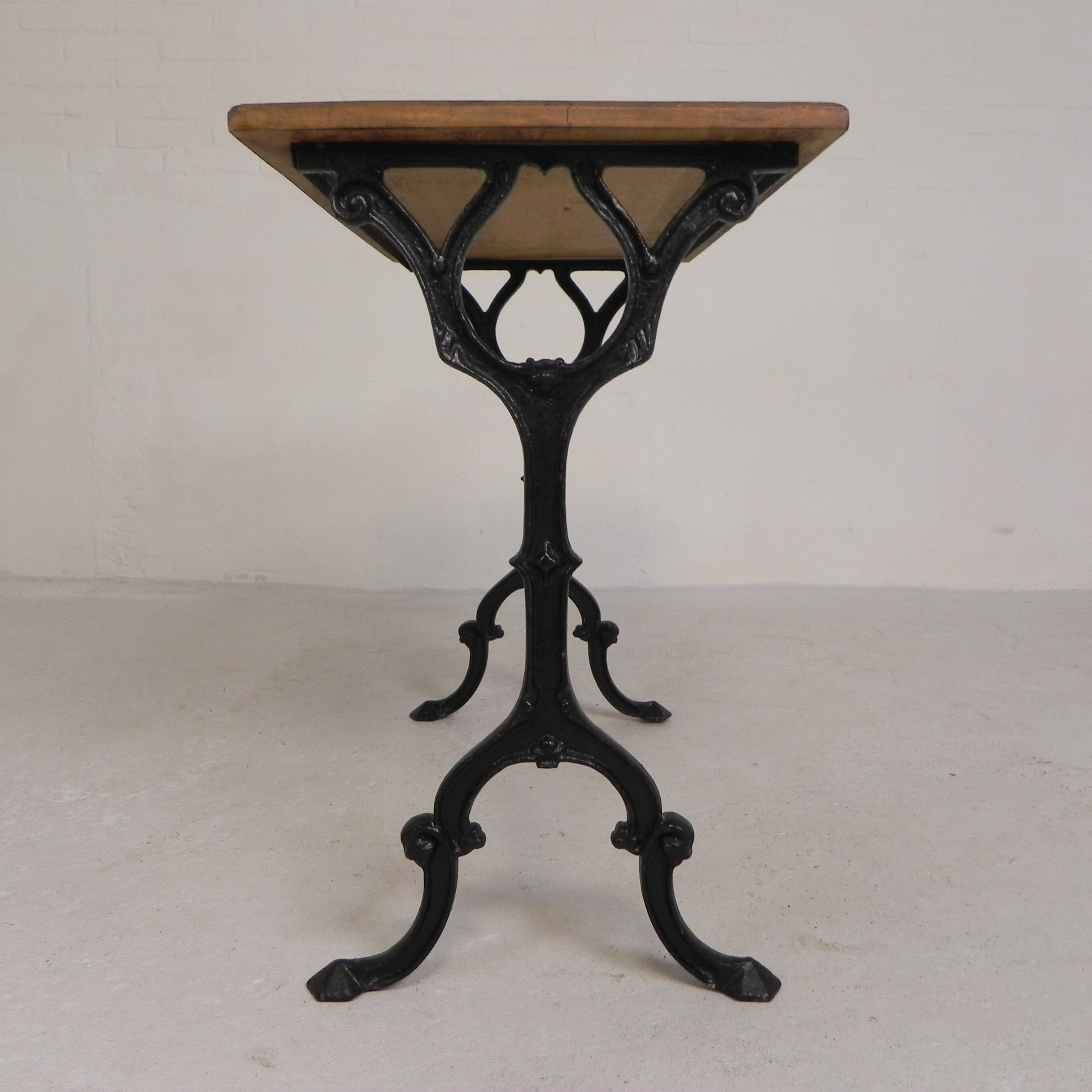 Bistro table with an oak top on a cast iron base, 1930s.