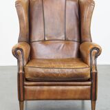 Sheep leather wingback chair finished with black piping
