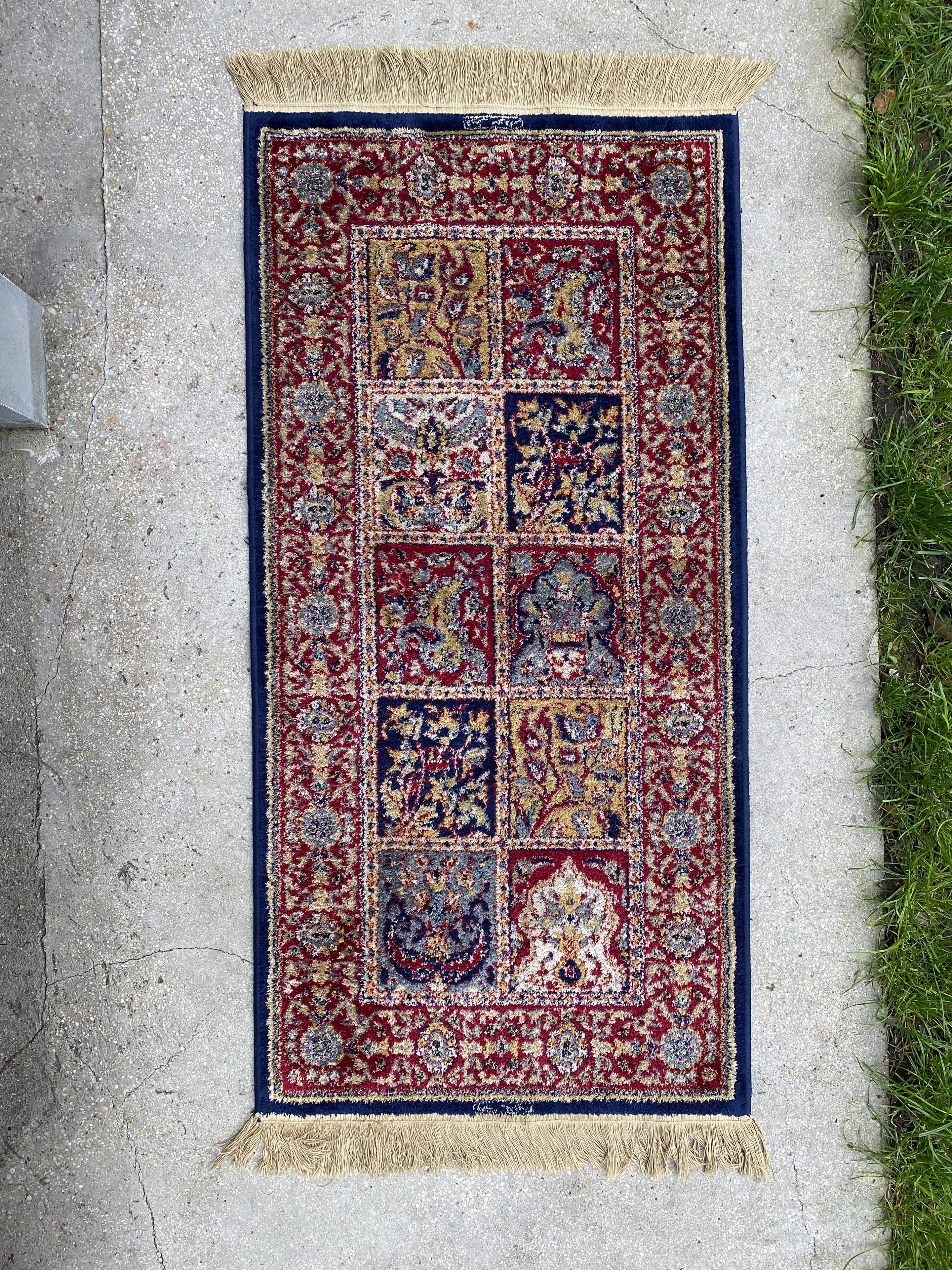 Vintage mechanical Turkish rug with box decoration on a red and navy blue background 139 x 68 cm