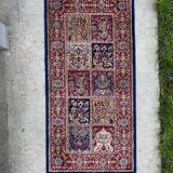Vintage mechanical Turkish rug with box decoration on a red and navy blue background 139 x 68 cm
