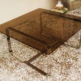 Table basse Roche Bobois 1970 verre fumé piètement en métal chromé.