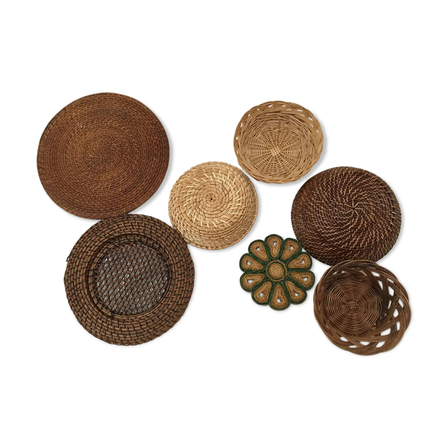 Wall composition of seven baskets and wicker trays.