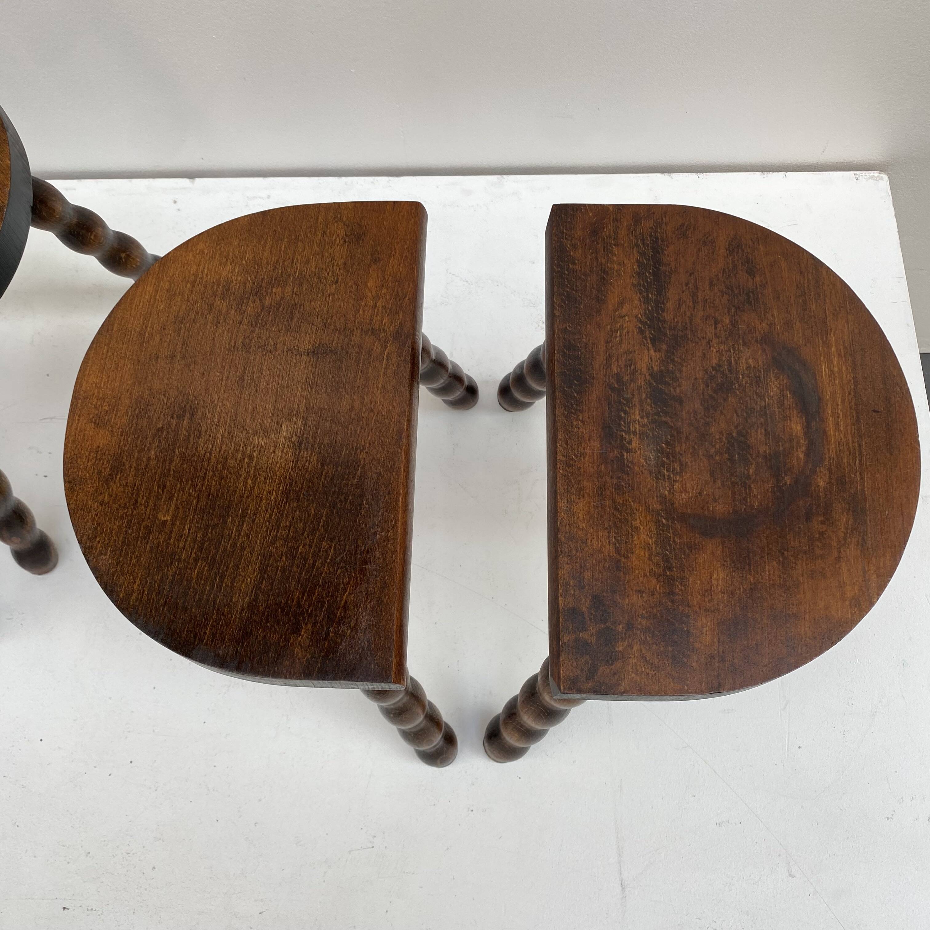 Series of 4 small tripod stools with half-moon seat and beaded turned wood legs