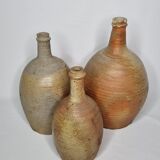 Set of three enamelled terracotta bottles