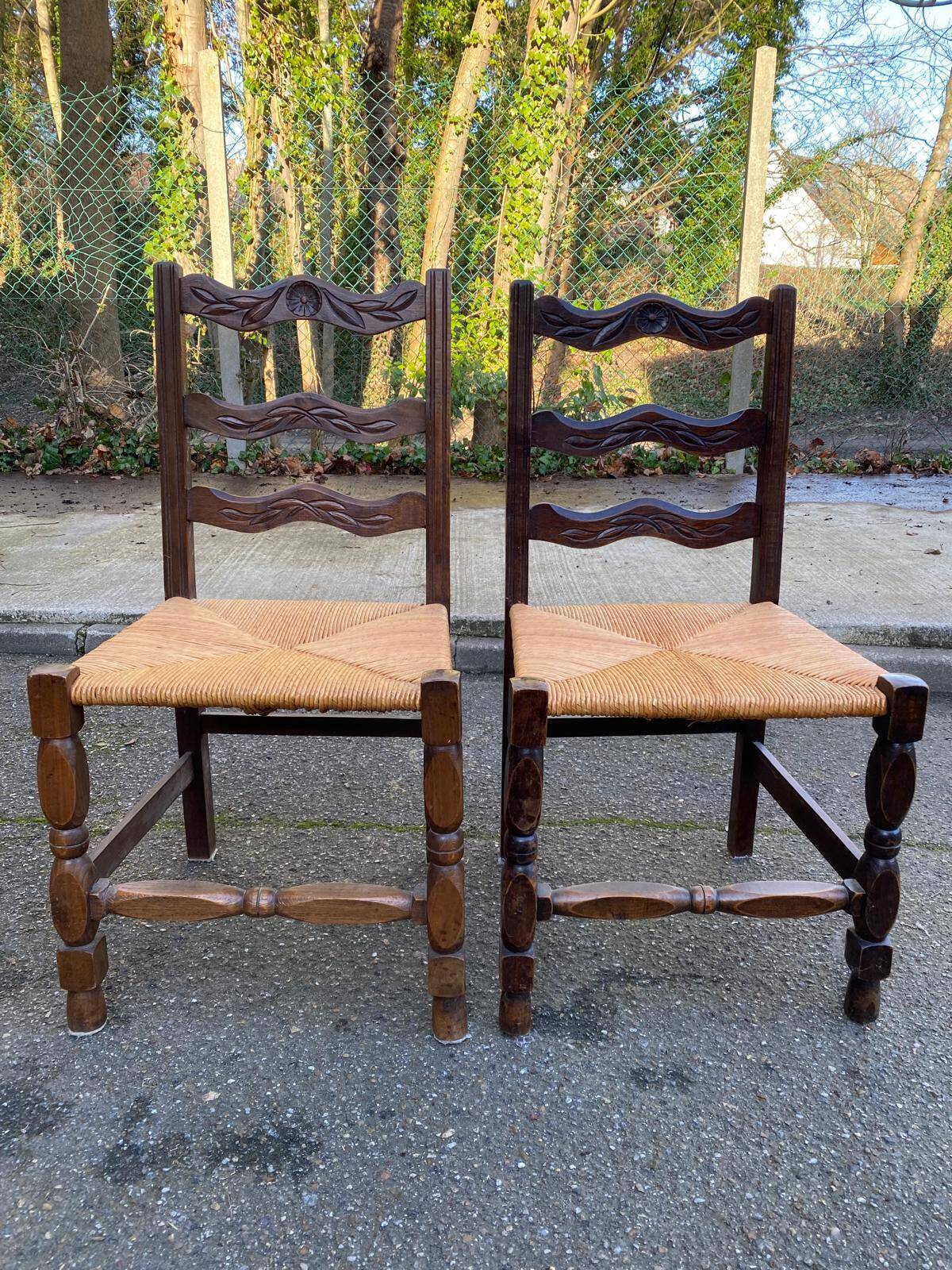 2 solid wood chairs with carved rush seats