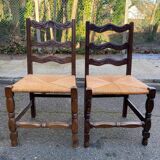 2 solid wood chairs with carved rush seats
