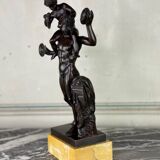 Dionysus on the shoulders of a satyr, bronze after the antique on a yellow Siena base.