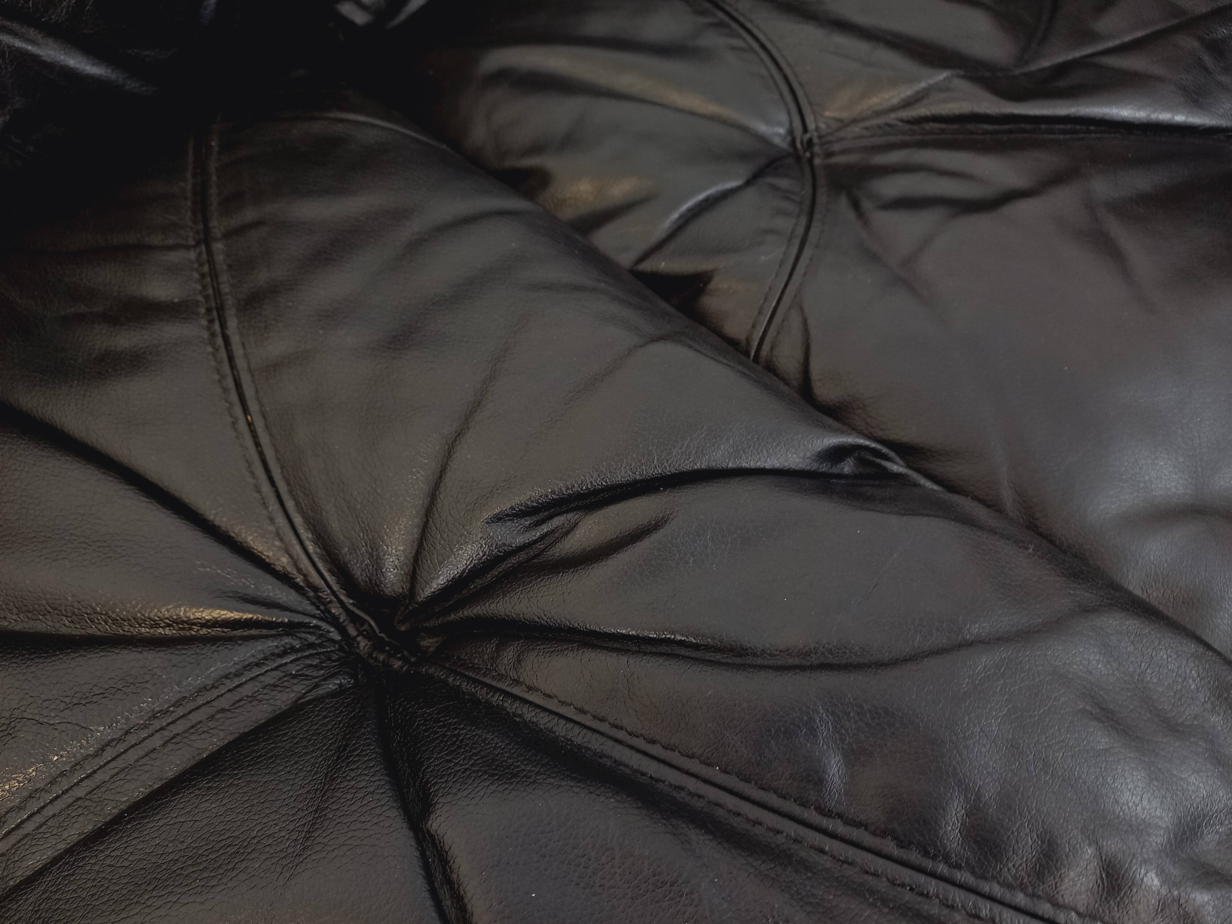 Vintage corner sofa composed of 3 modules in black leather with integrated bed.