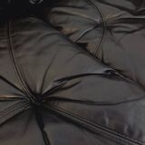 Vintage corner sofa composed of 3 modules in black leather with integrated bed.