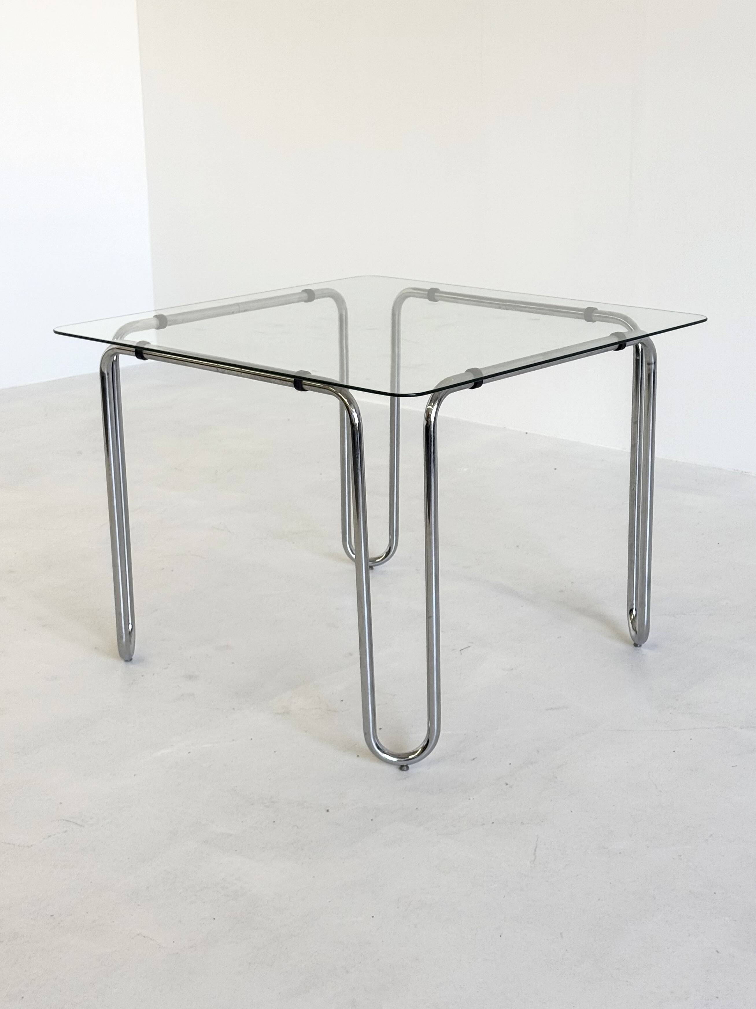 Italian vintage dining table with smooth glass and tubular frame base