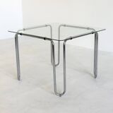 Italian vintage dining table with smooth glass and tubular frame base