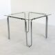 Italian vintage dining table with smooth glass and tubular frame base