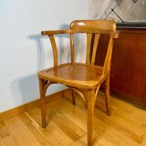 Antique curved wooden armchair in Baumann style