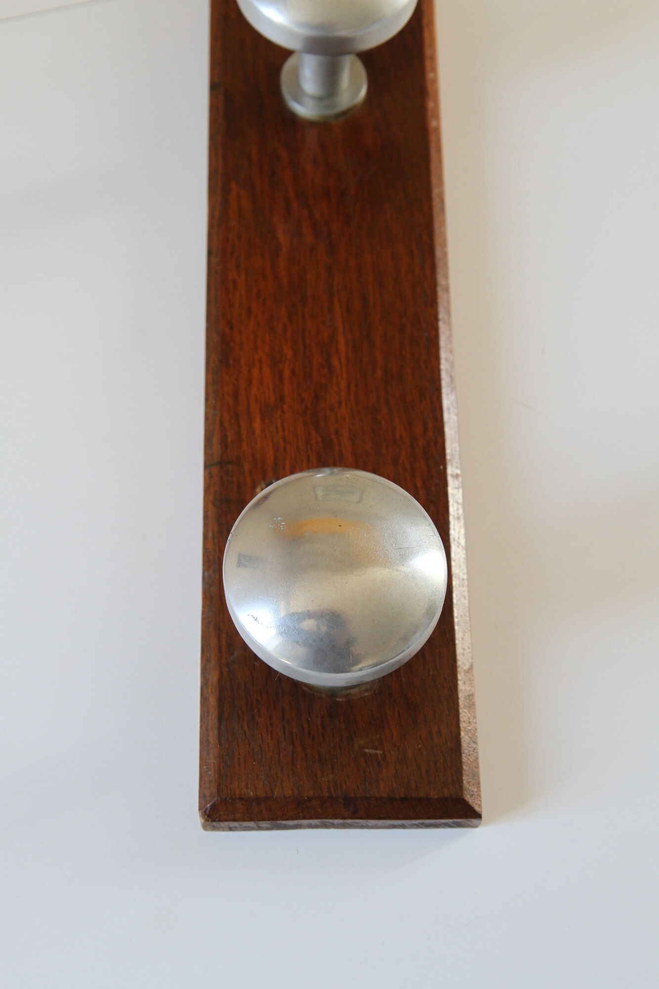 Wooden and stainless steel coat holders from the 1920s