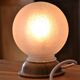 White glass globe table lamp with geometric reliefs
