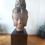 Head of Buddha on wooden base. Resin sculpture from Japan