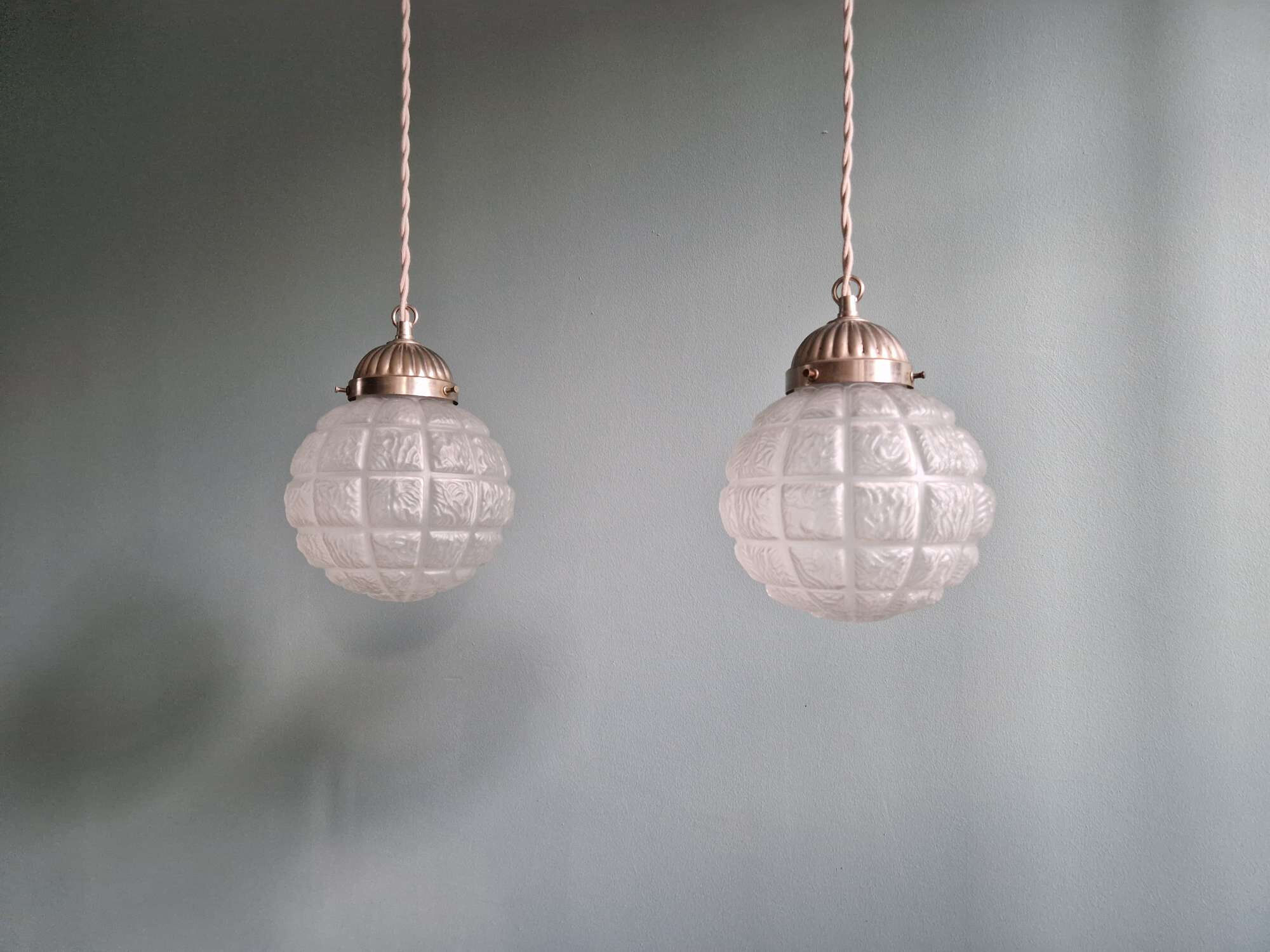 Pair of Art Deco frosted glass pendants, 1920s-30s.