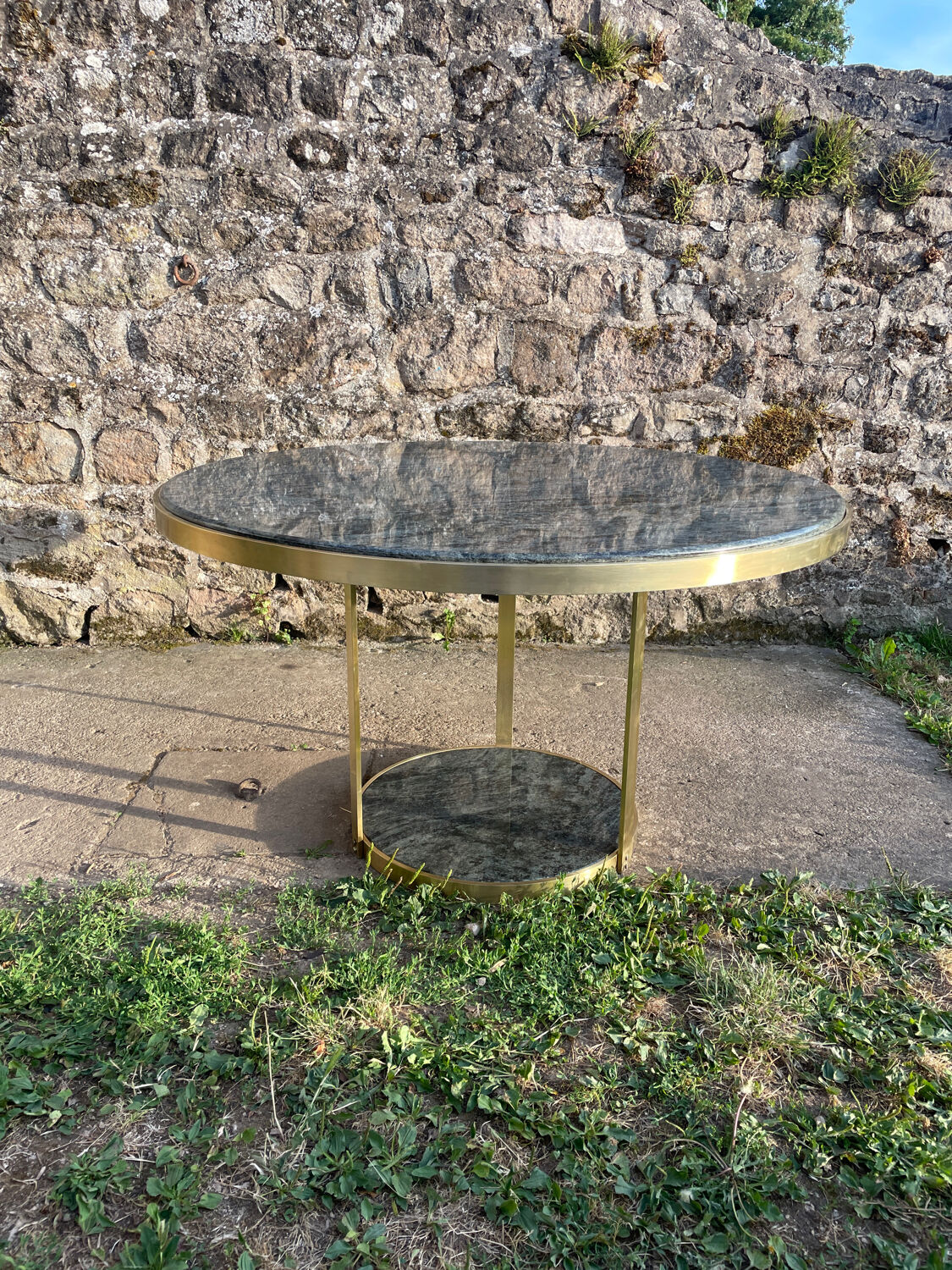 Round dining table with green marble and solid brass.