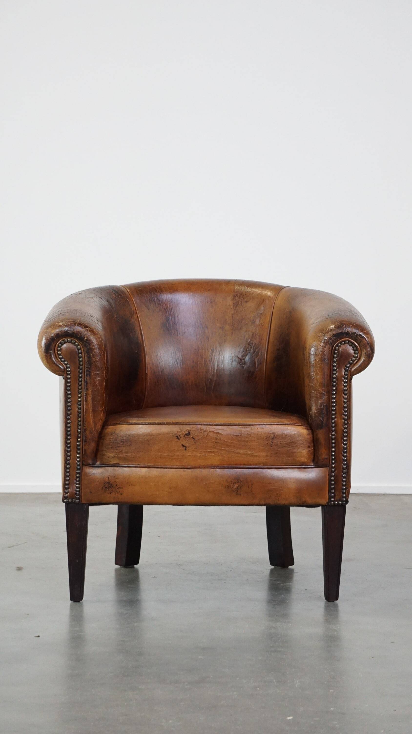 Sturdy, stately and subtle vintage sheepskin club chair