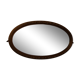 Beveled oval mirror in gilded wood