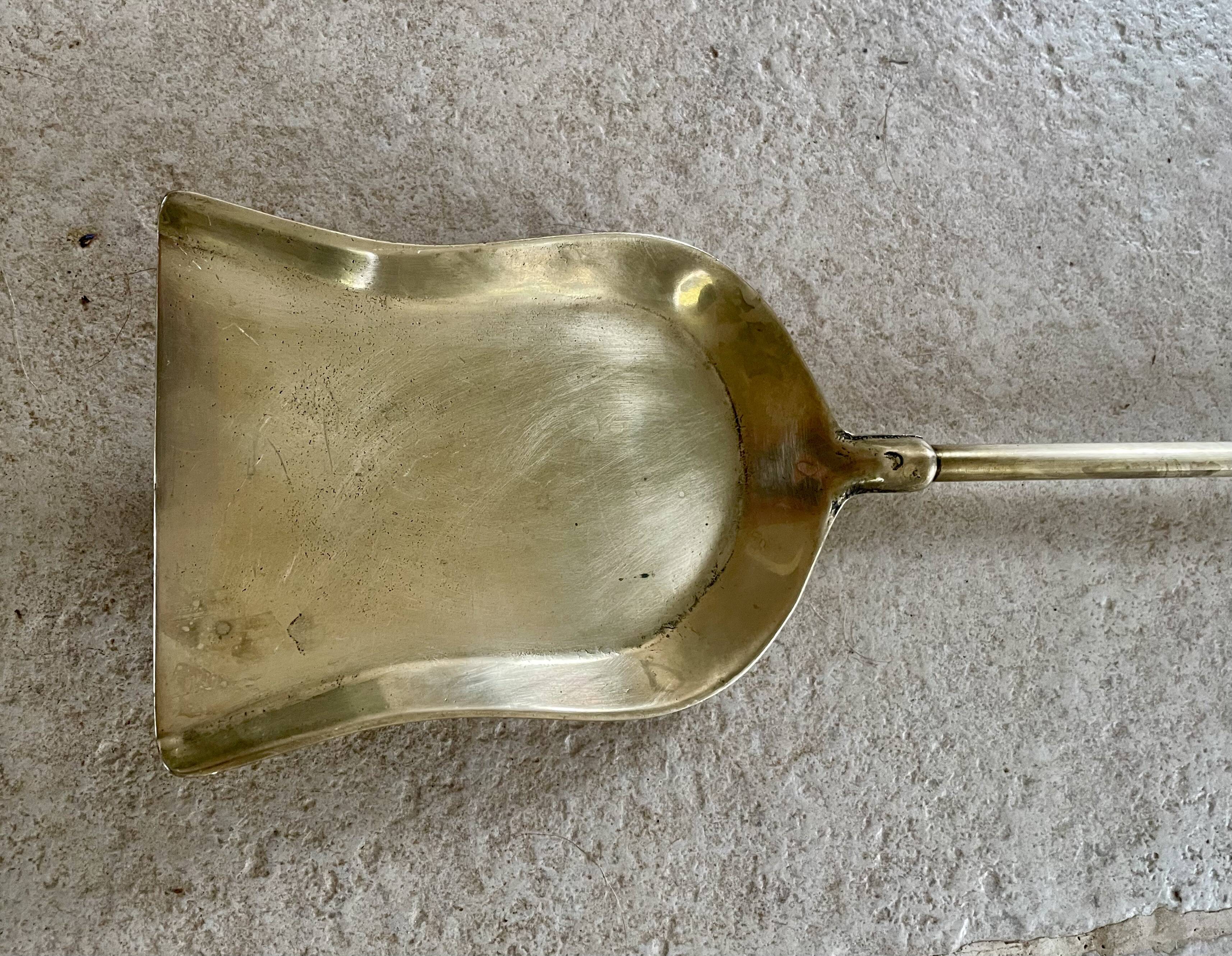 Brass fireplace tools in the style of Maison Baguès.