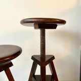 2 tripod stools with dark wood screws