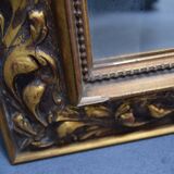 wall mirror in a decorative wooden frame.