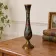 Vintage brass soliflore vase with black, red, and green floral decoration – H 18 cm