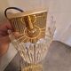Pair of wall lights with hanging glass pendants in gold color
