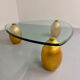 Vintage Italian design coffee table with a glass top and gold base, dating from the 1980s.
