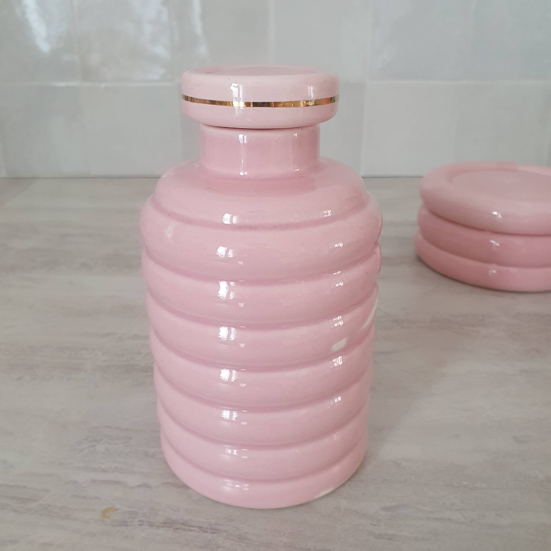 Set of pink and gold ceramic bathroom accessories