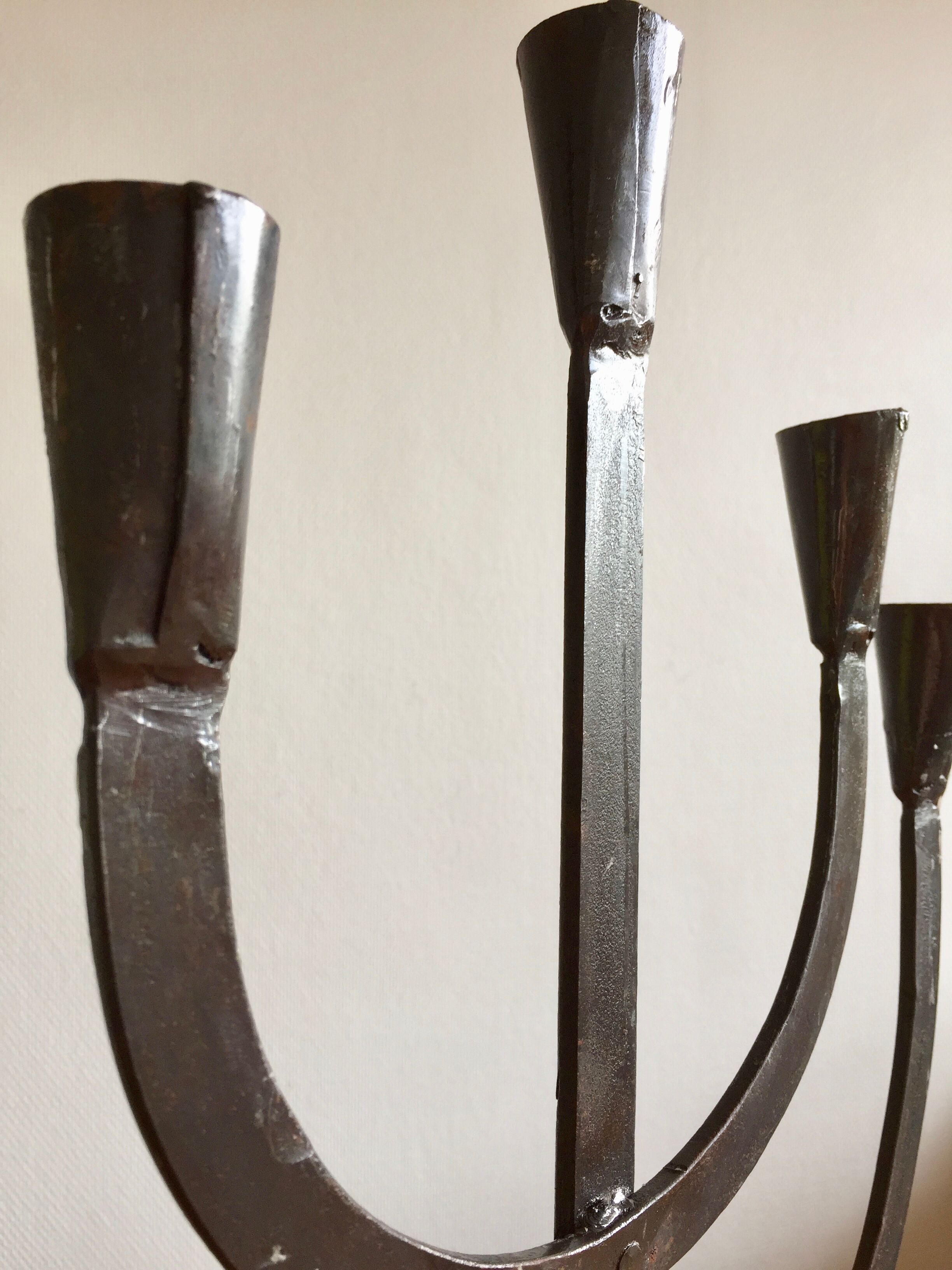 Old iron candelabra shaped high time