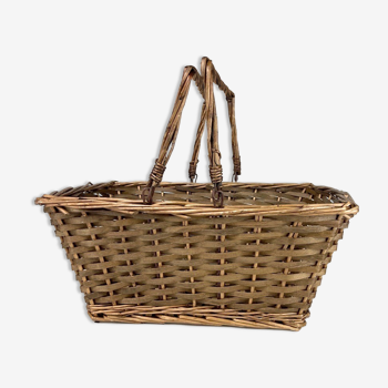 Old basket made of woven wood splices and braided wicker