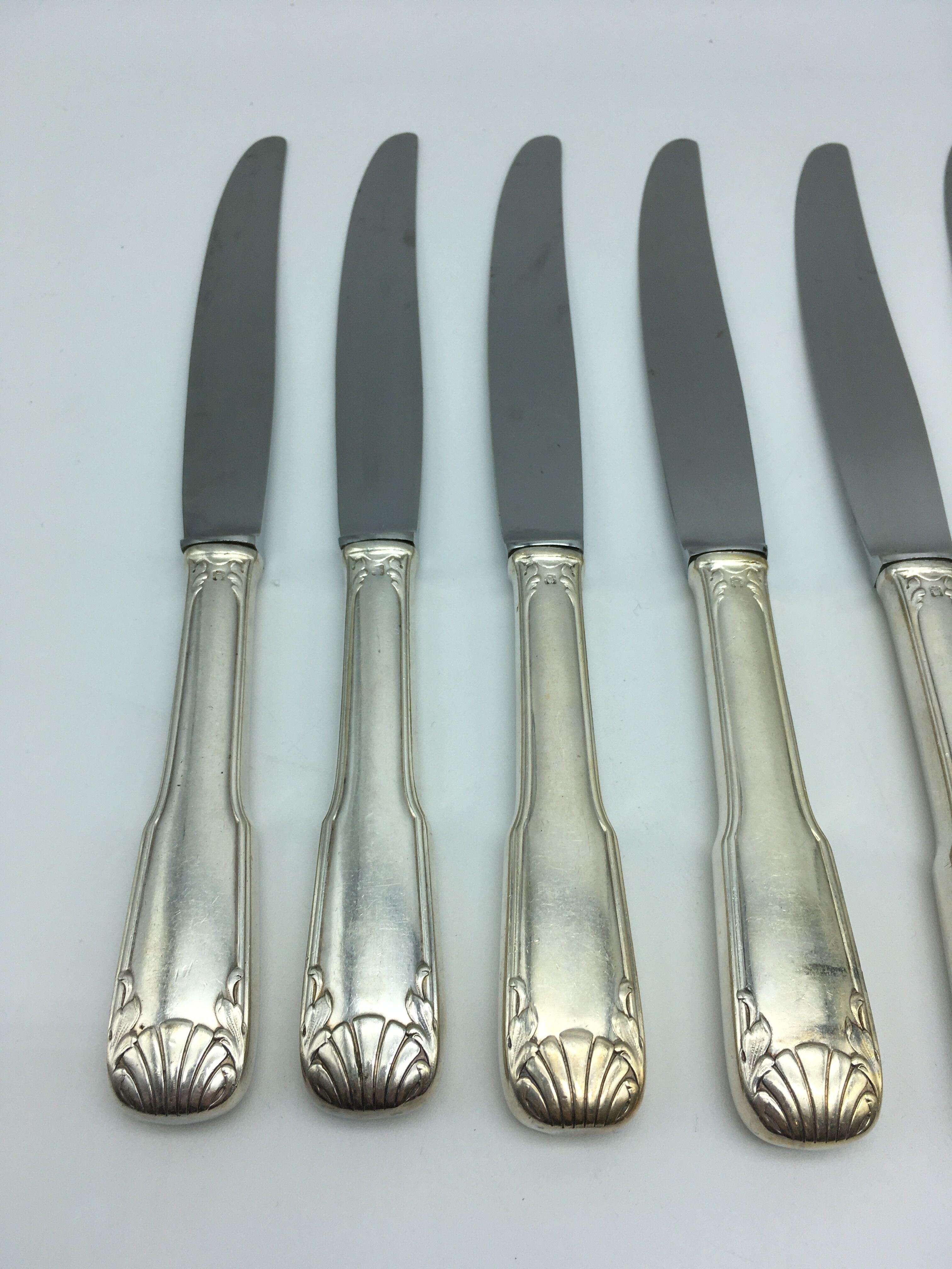 12 silver metal knives.