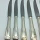 12 silver metal knives.