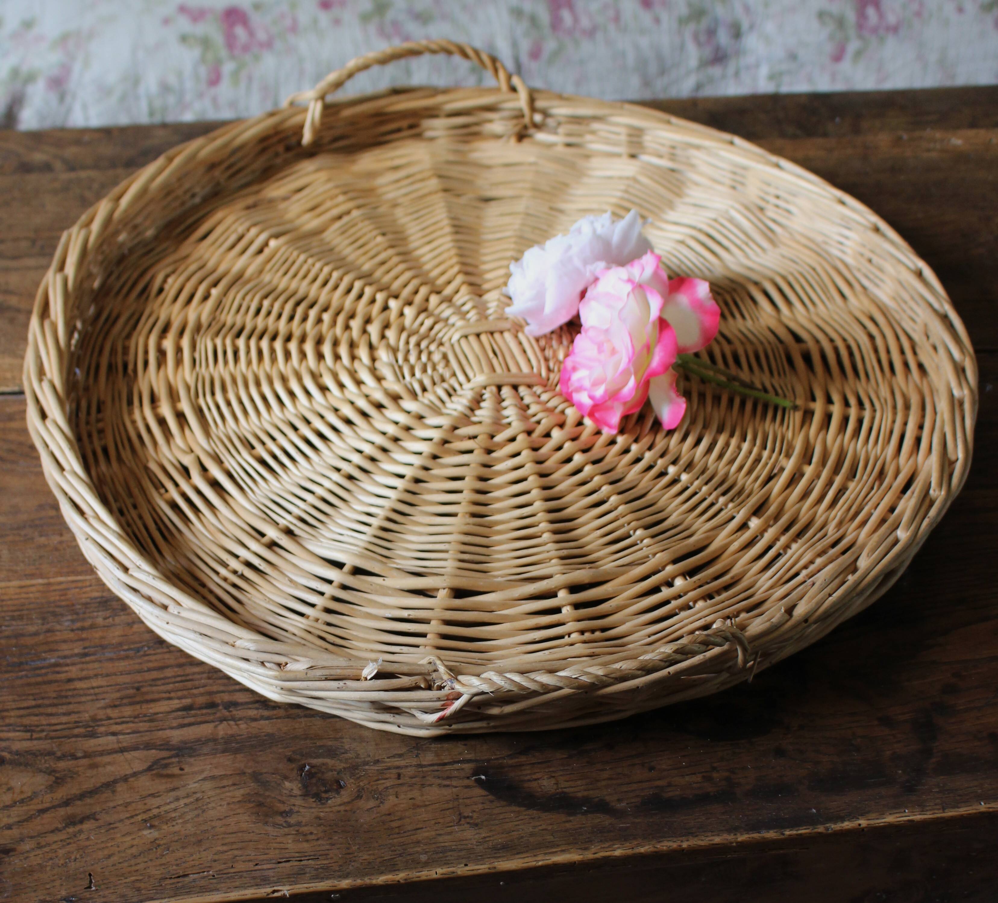 Large round wicker tray with two handles, vintage weaving.