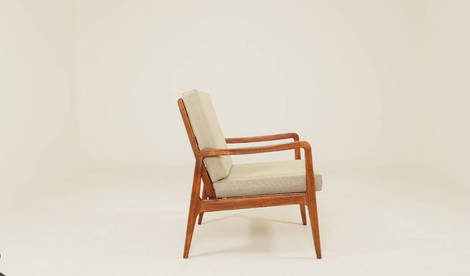 Vintage armchair in olive corduroy with a wooden frame.