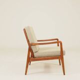 Vintage armchair in olive corduroy with a wooden frame.