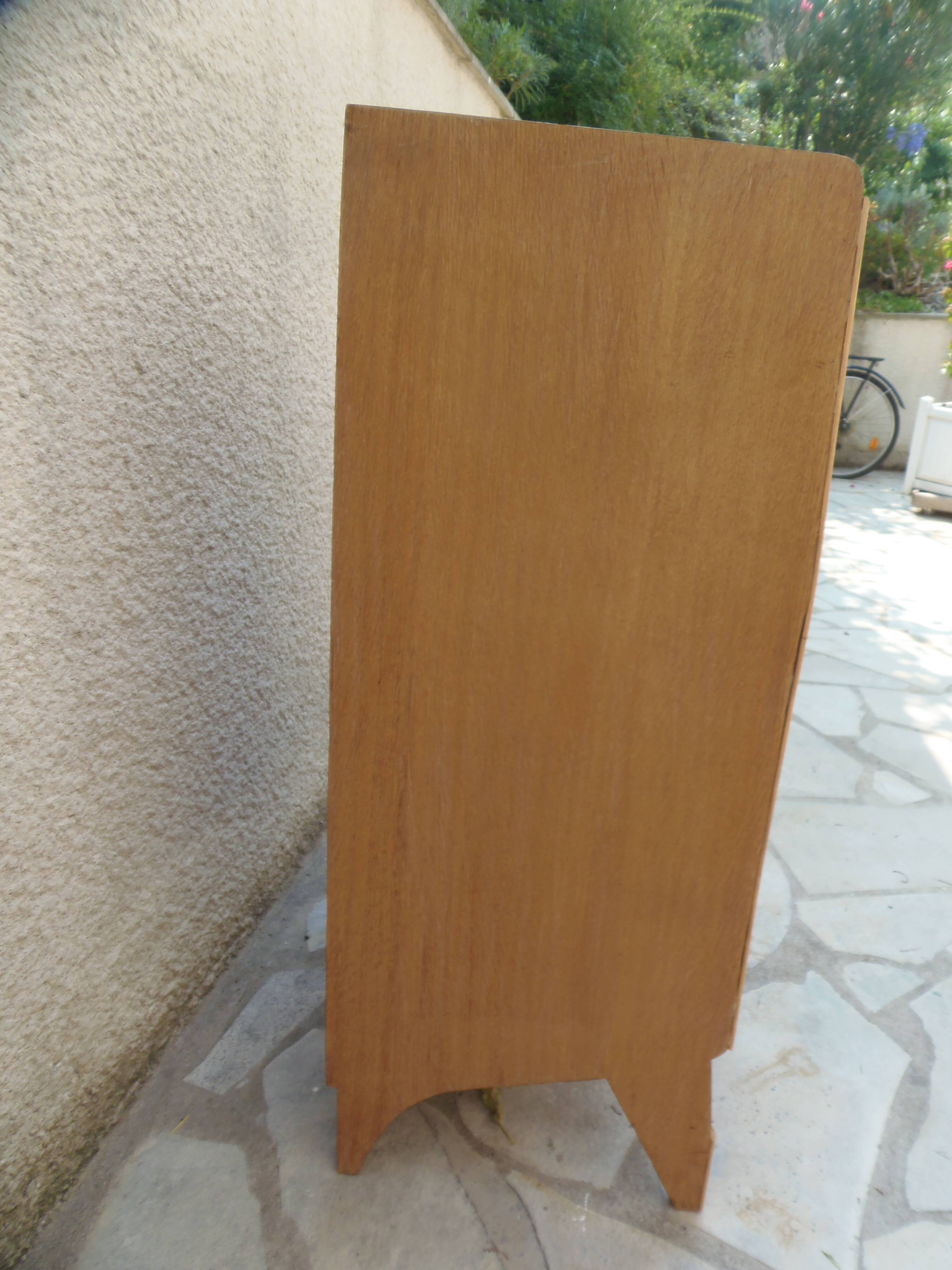 Vintage chest of drawers in raw wood.