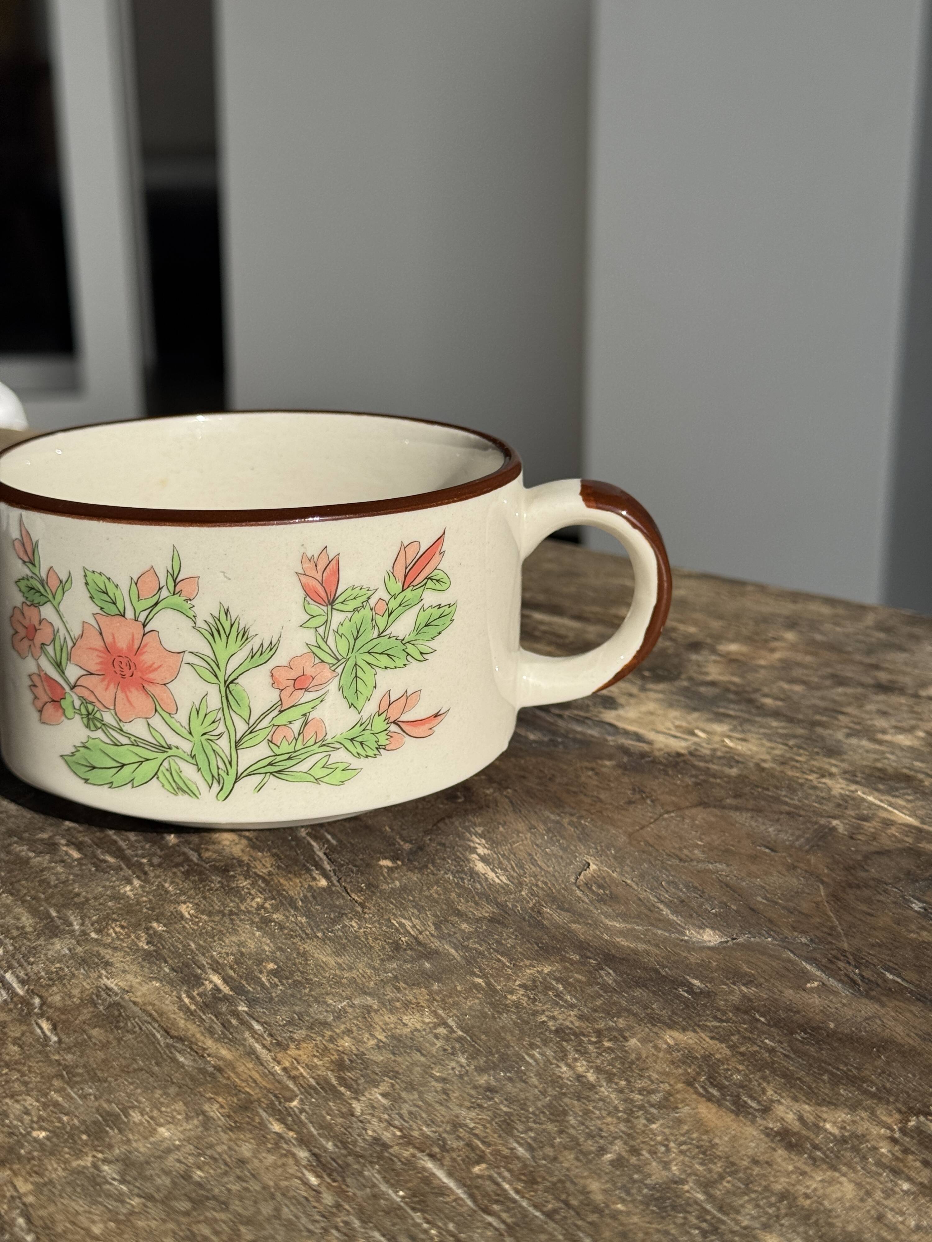 Small speckled stoneware cup made in Korea with a floral pattern H7 D11