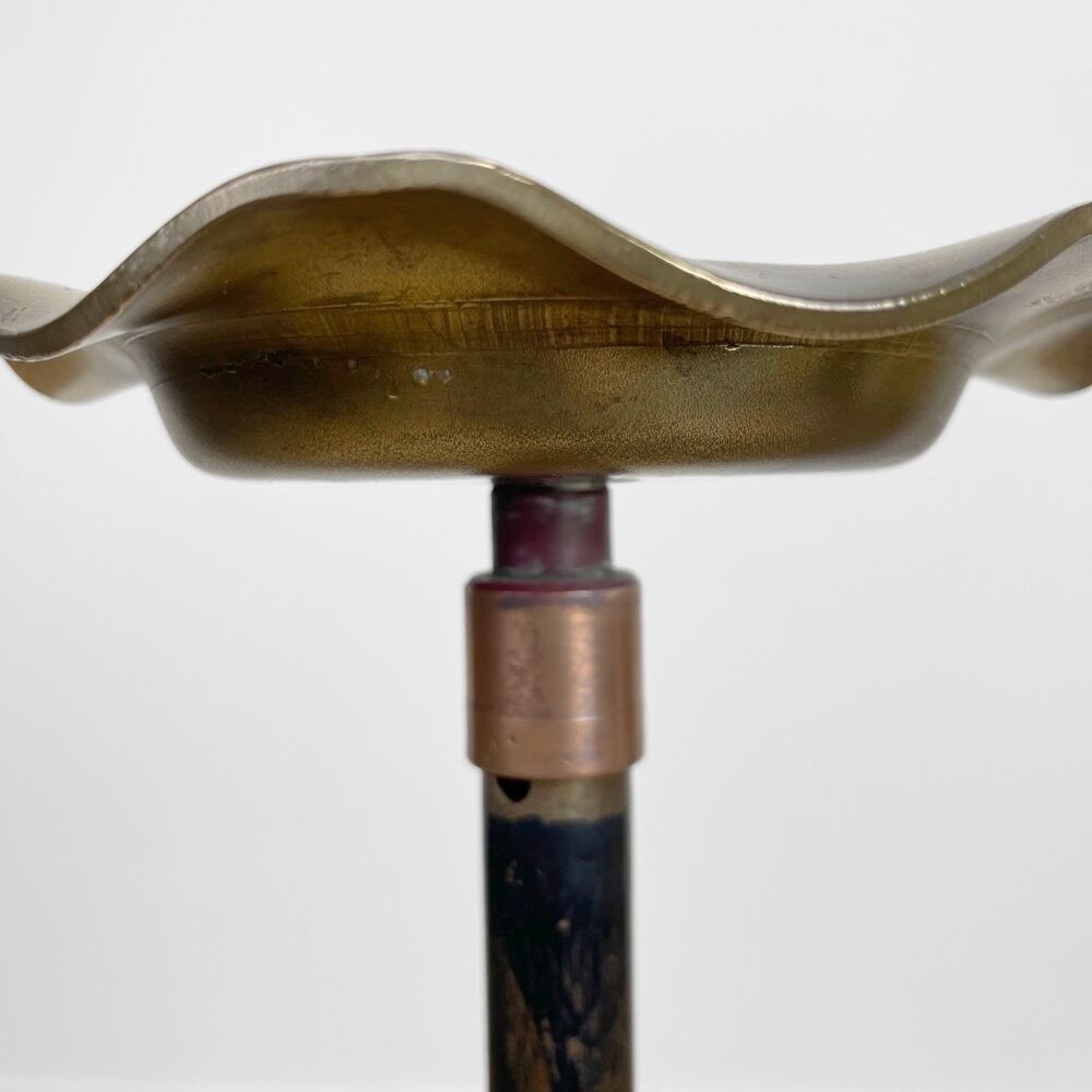 Brass ashtray on metal stand and wooden base
