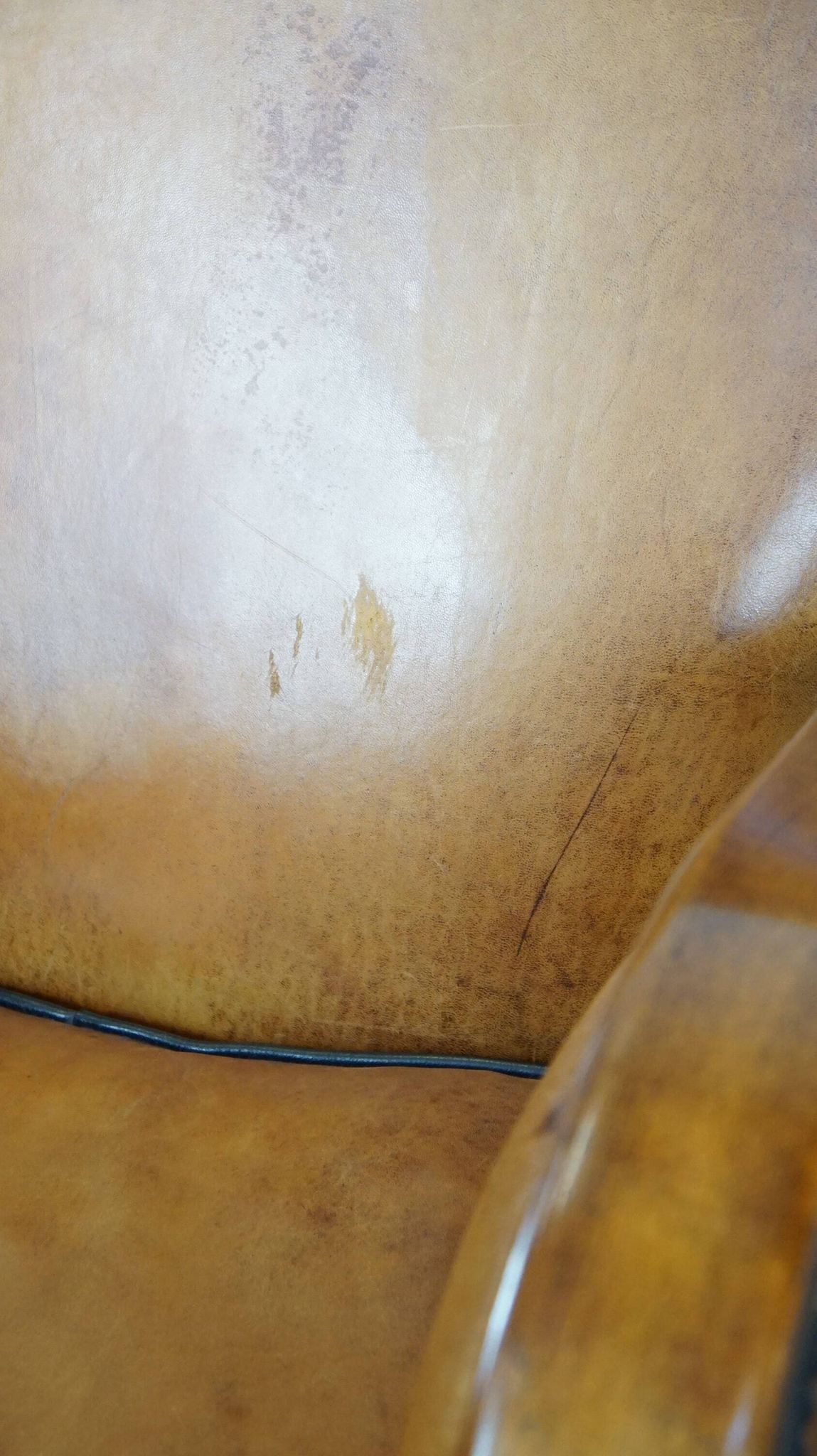 Unique, luxurious sheepskin armchair combined with wood and finished with decorative nails