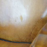 Unique, luxurious sheepskin armchair combined with wood and finished with decorative nails