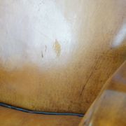 Unique, luxurious sheepskin armchair combined with wood and finished with decorative nails