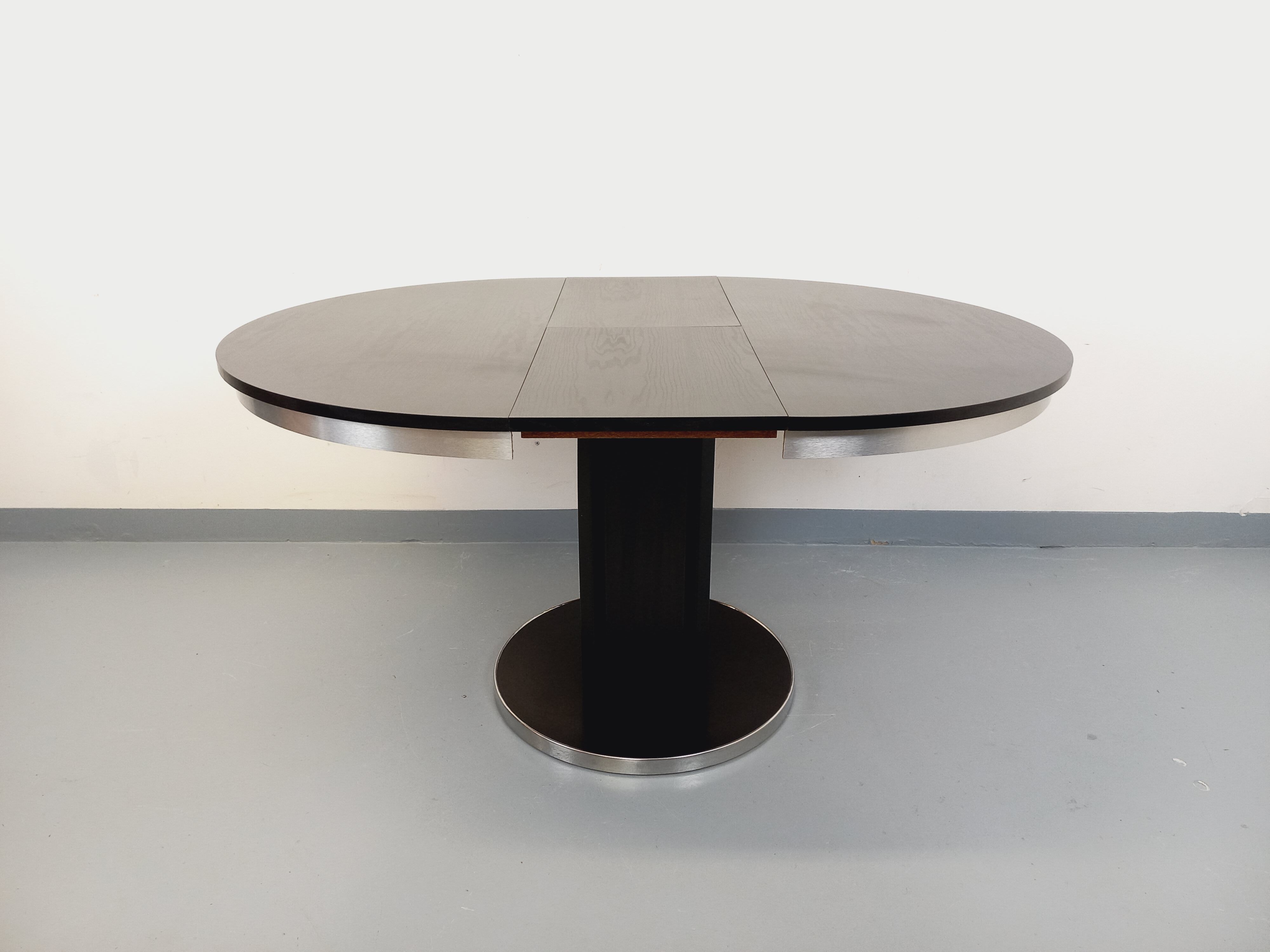Vintage dining table in melamine with a black wood effect and chrome metal.